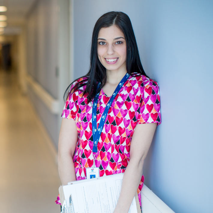 Students-student in scrubs posing in hospital hallway-710x710 Administration at a hospital
