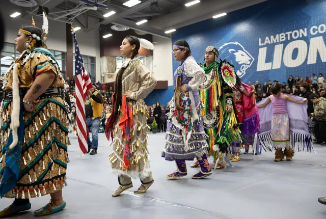 An image of indigenous people at a PowWow ceremony at Lambton College.