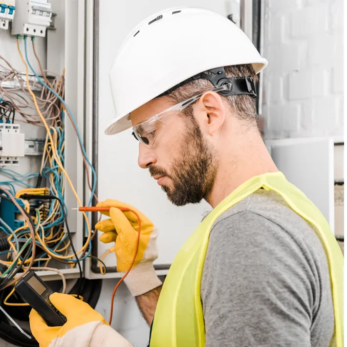 A stock photo of an electrician looking at wires.