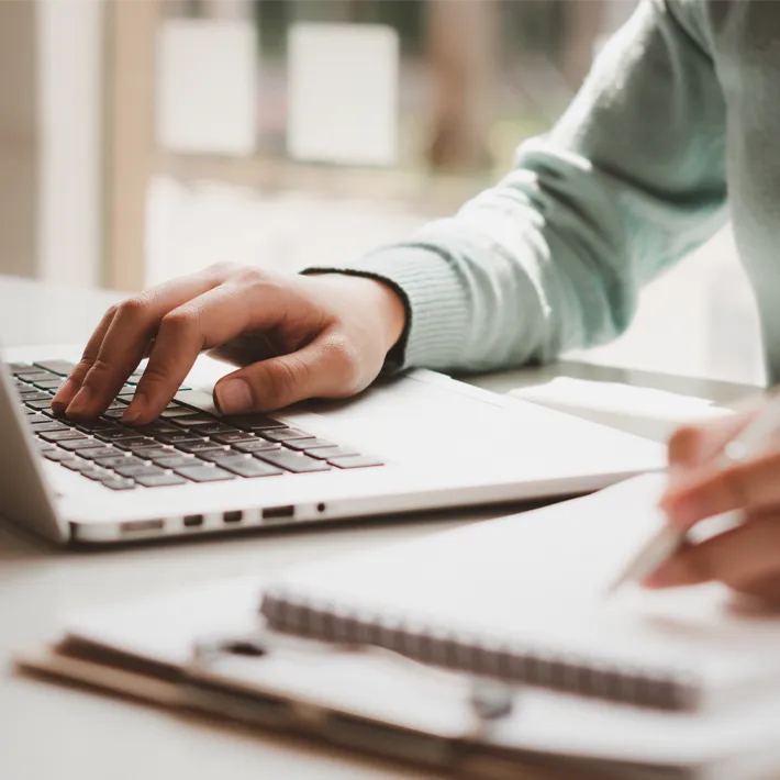 Female hand typing on a laptop