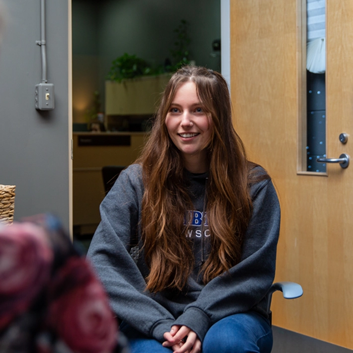 A student speaking with a counsellor in her office.