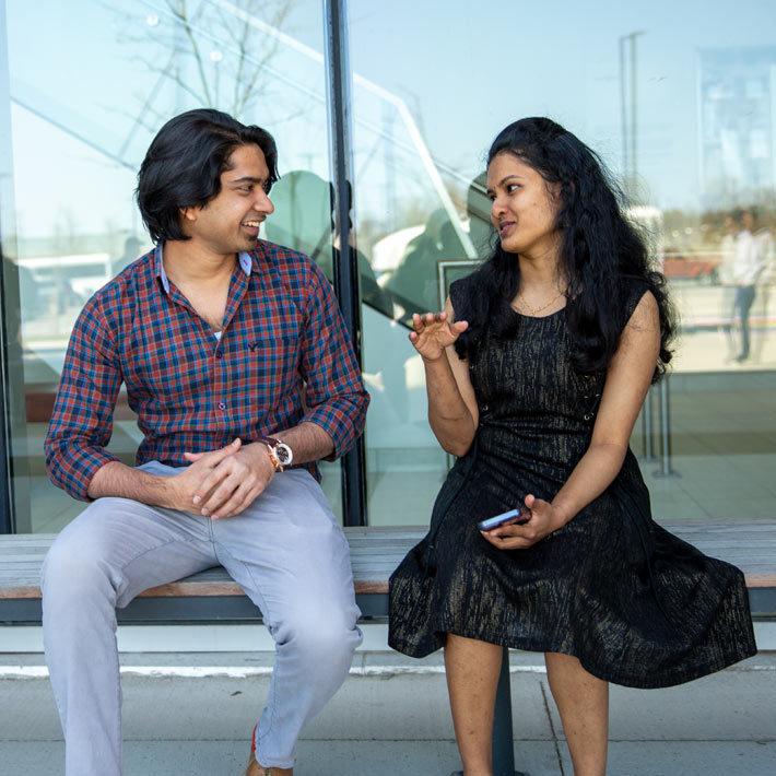 Two international students chatting outside