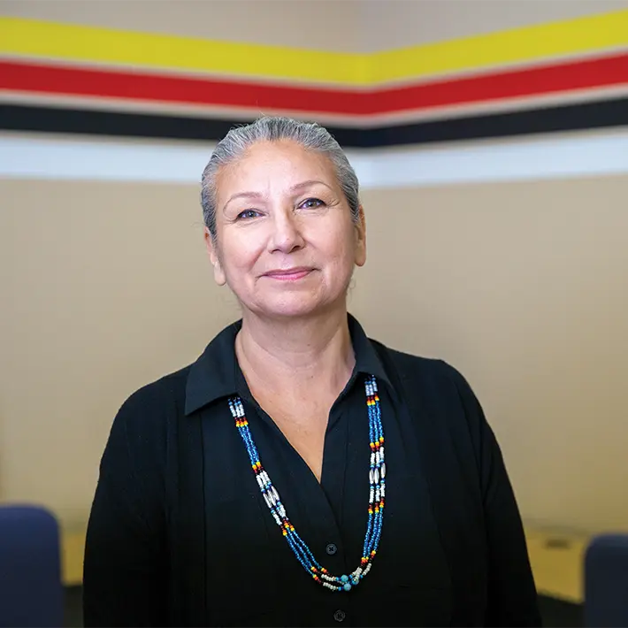 Indigenous support team member posing for photo.