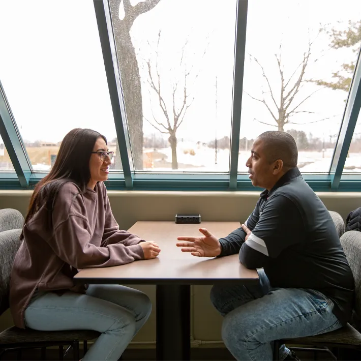 Students talking to one another at table