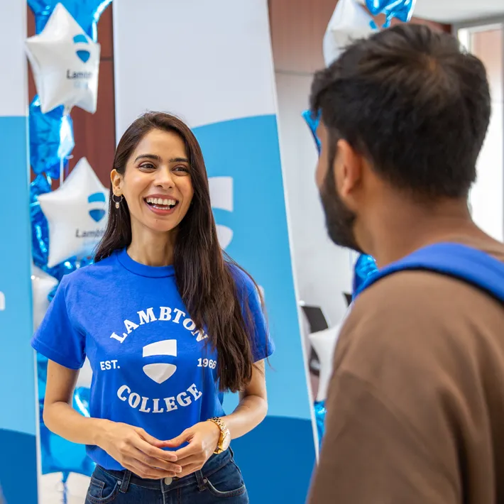 Student Ambassador smiling looking at a prospective student.