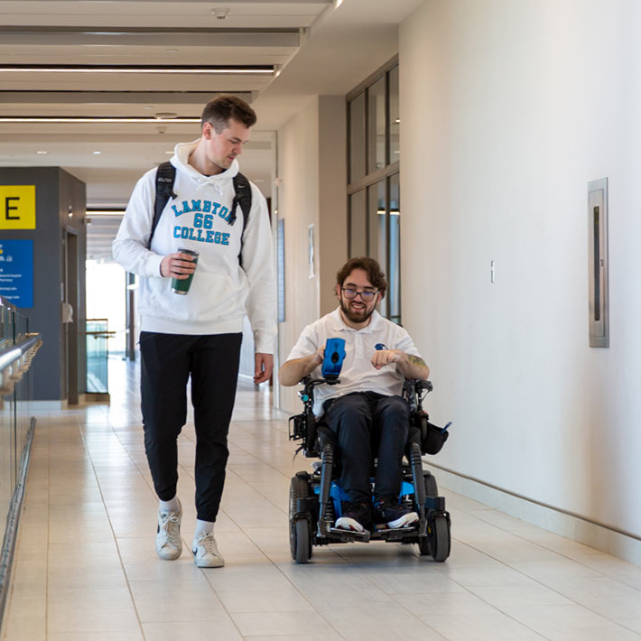 Two students walking down a hallway