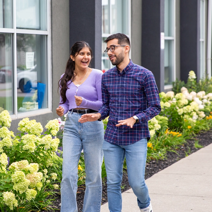 Two students walking outside the Cestar campus-International Education.