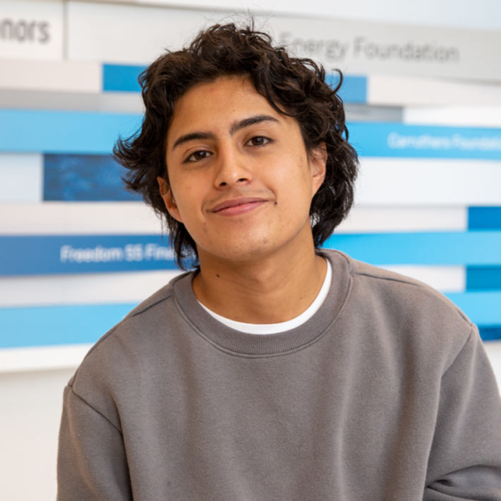Young male student in front of donor wall