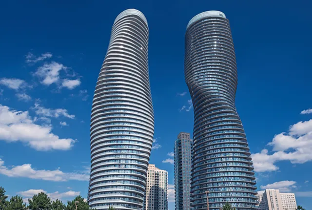 A photo of the iconic Abosolute World towers in Mississauga with clear sky.