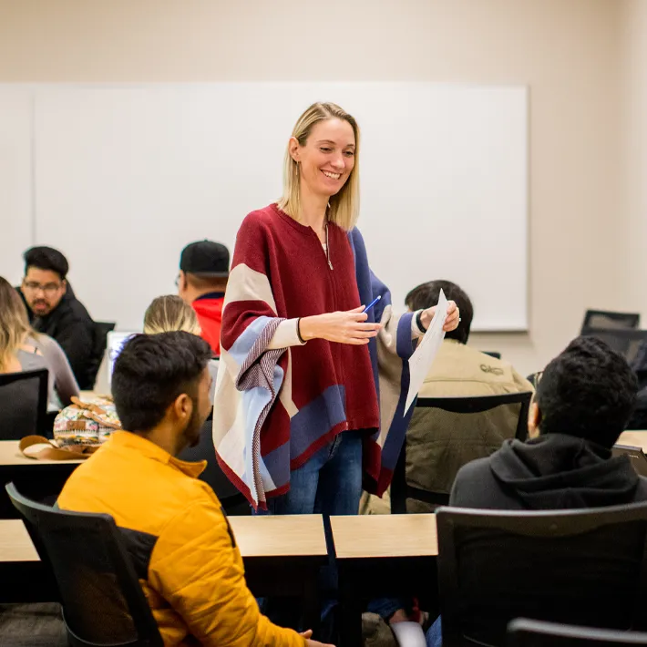 Teacher instructing students in classroom.