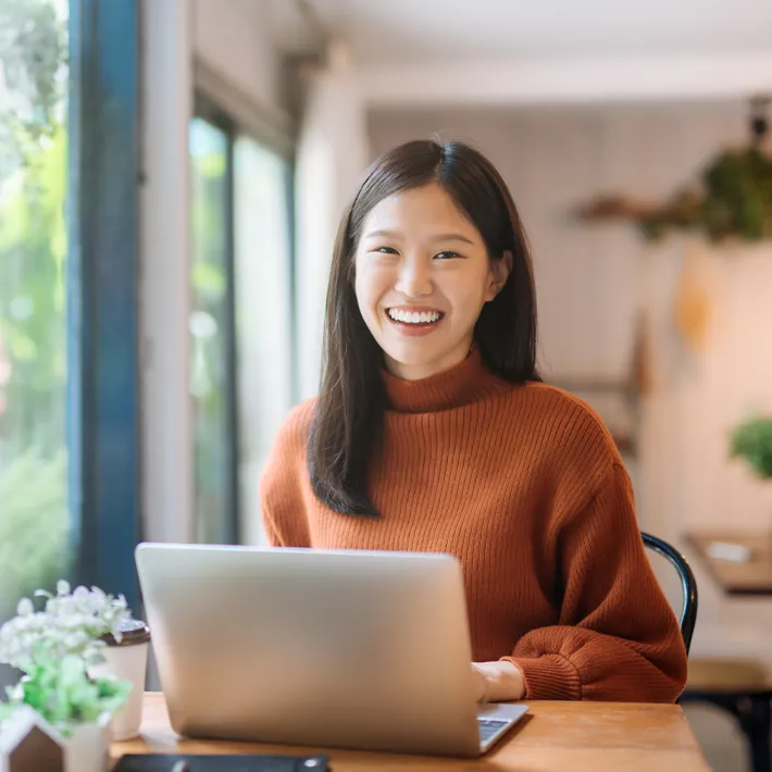 Online education student at desk with computer.