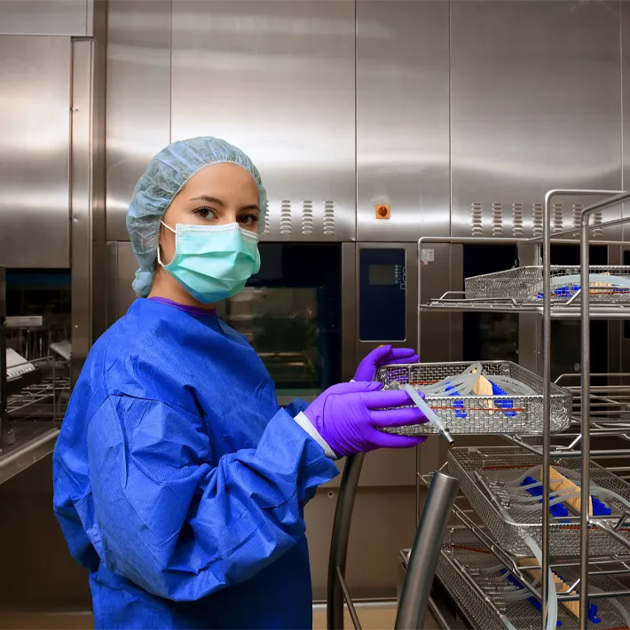 A women sterilzing and processing medical equipment.