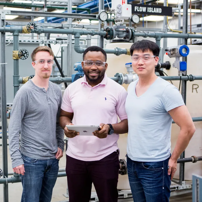 ICECT students in industrial lab posing for photo.