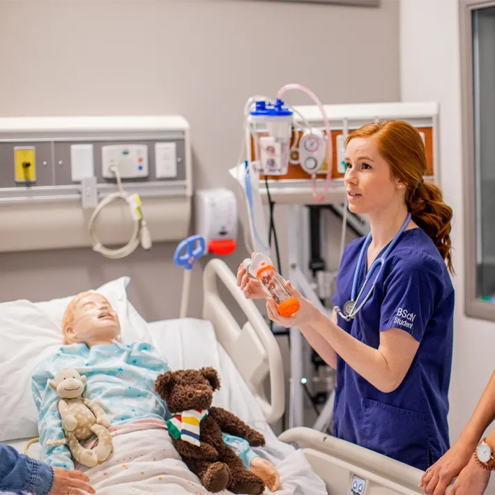 Image of a nursing student practising in simulation lab. 