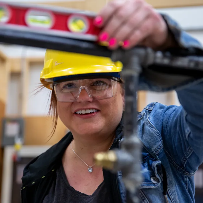 Student measuring pipe.