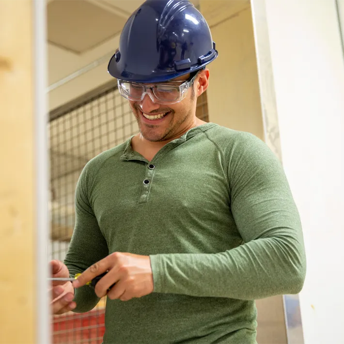 A student screwing a bolt in workshop.