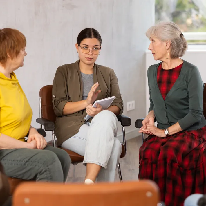 A recreation therapist speaking with senior group.