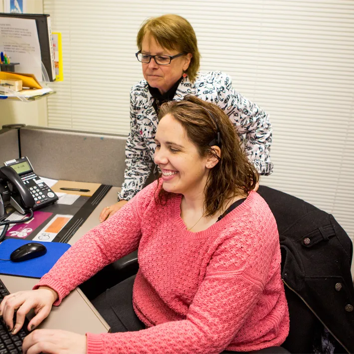 Social worker student and teacher looking at computer.