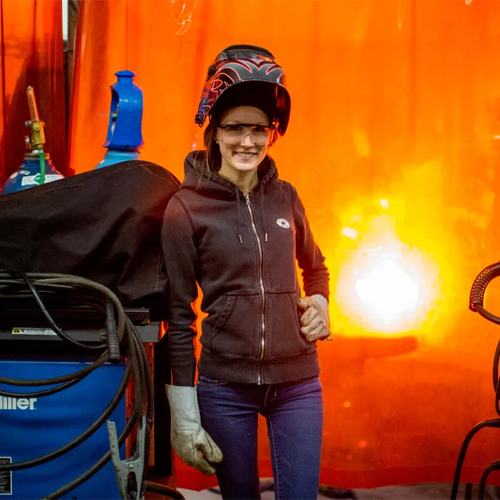 Student in welding shop posing for photo.