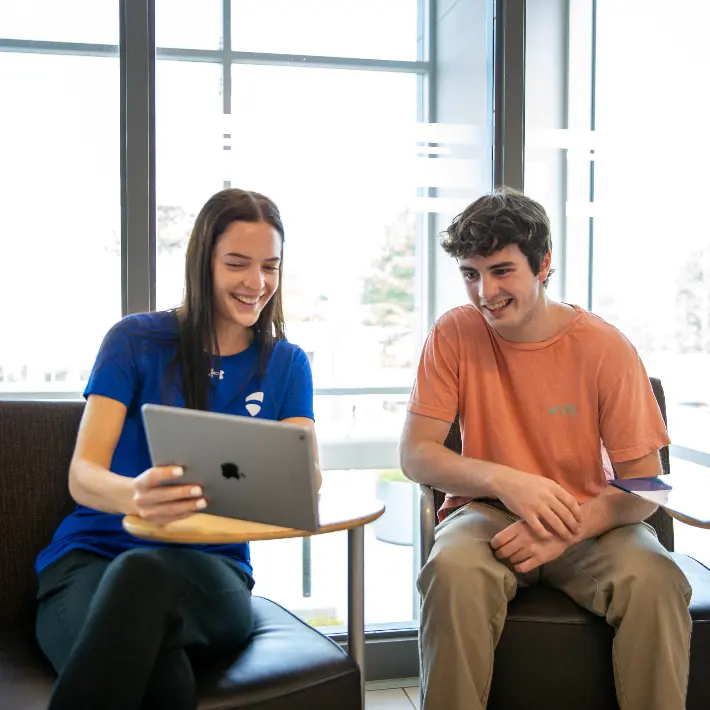 A recruiter helping a student with an iPad