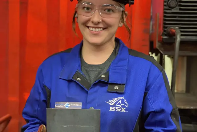 Student holding a trophy at Women of Steel Event