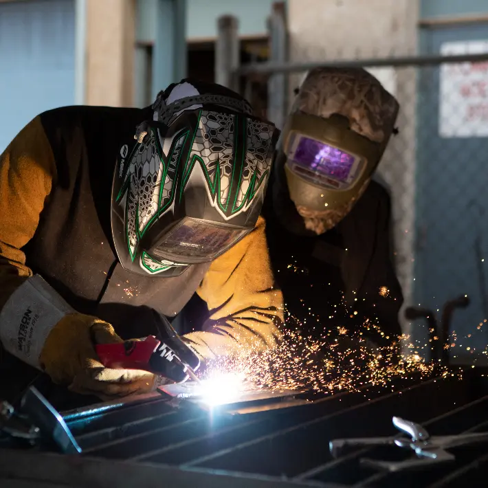 Two students welding