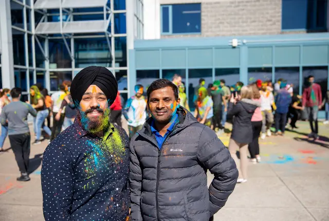 Two happy students at Holi Festival