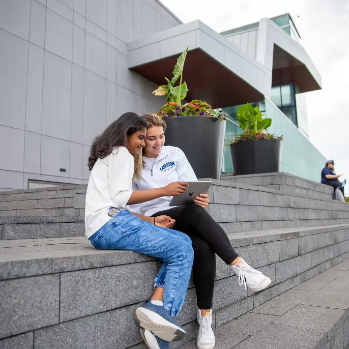 students-outdoors-international Two students sitting outdoors on the steps