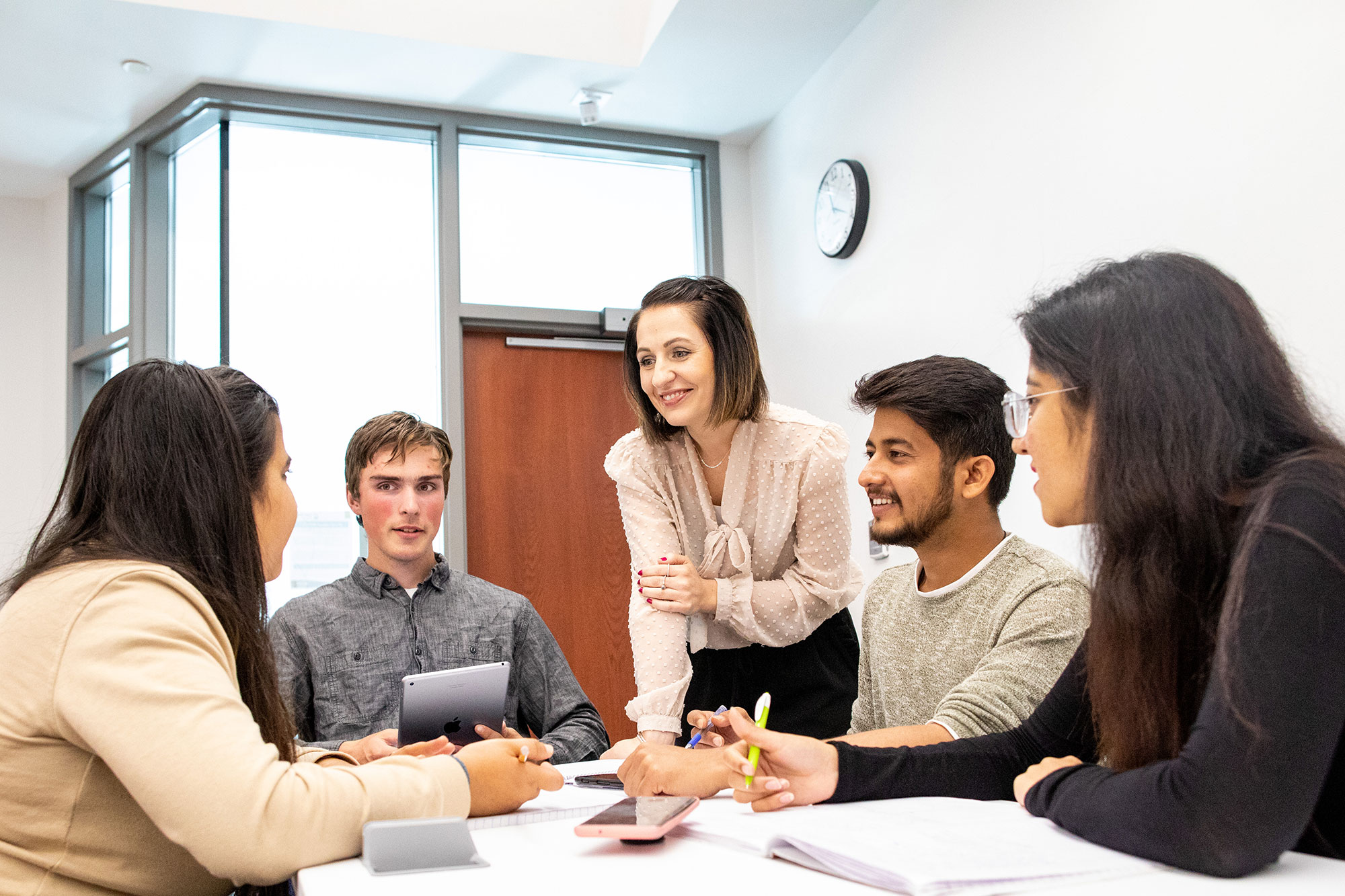 A professor instructing a group of students